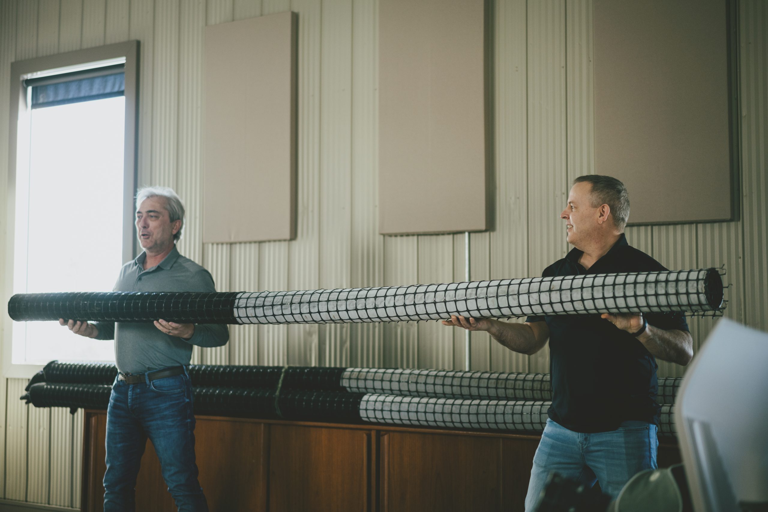 2 men holding spring drain